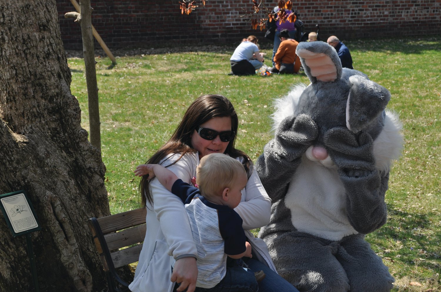 The Easter Bunny plays peek-a-boo with Hudson Stone, 1-1/2, held by Kelsey Stone on the grounds of the General Lew Wallace Study & Museum Sunday.